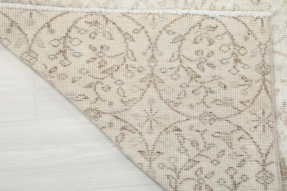 Close-up of the back of the hand-knotted rug, showing the cotton foundation and knotting