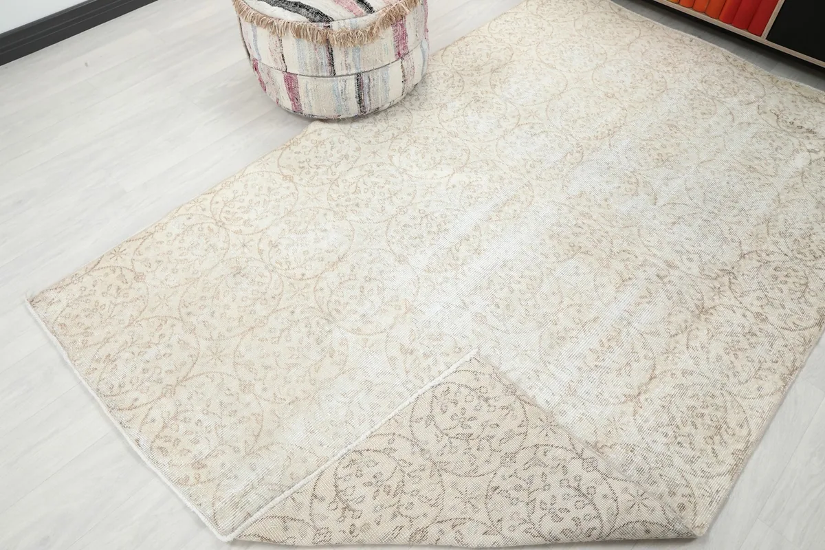 View of the rug folded back slightly, revealing the underside and showing the full pattern