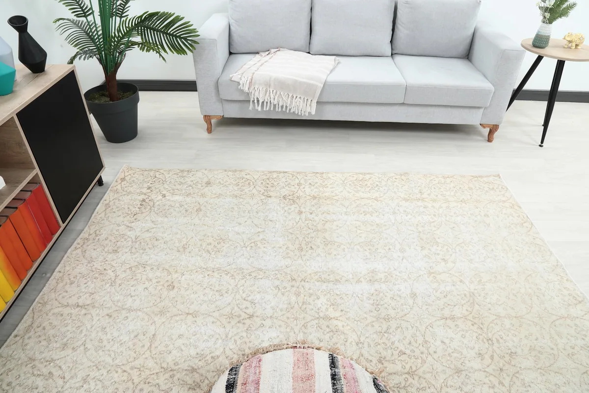Overhead shot of the ivory rug in a room setting, highlighting its full pattern and size