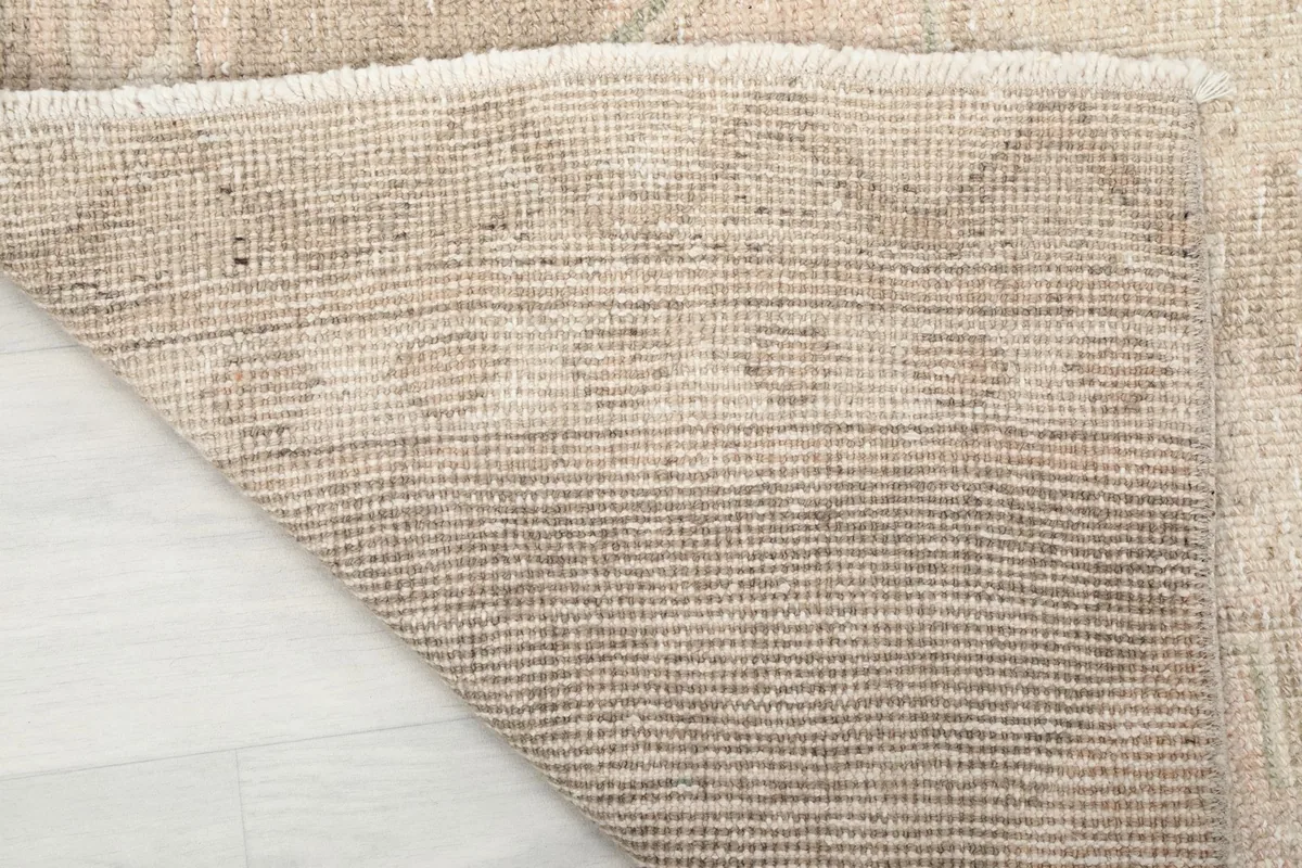 Underside view of the runner rug, revealing the cotton foundation and tight knotting.