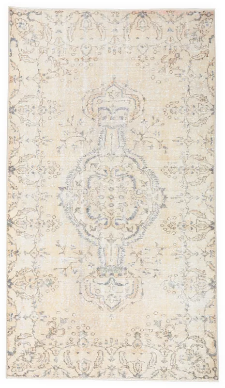 Top view of an ivory and blue vintage Anatolian rug with a central medallion
