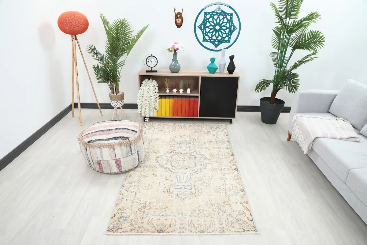 Ivory and blue vintage rug in a modern living room setting with a light gray sofa