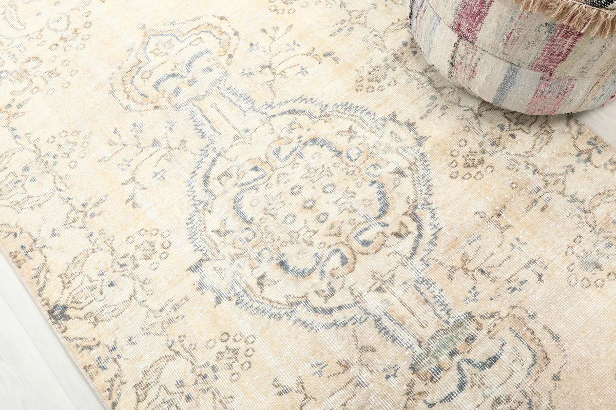 Detailed view of the central blue medallion and surrounding floral patterns