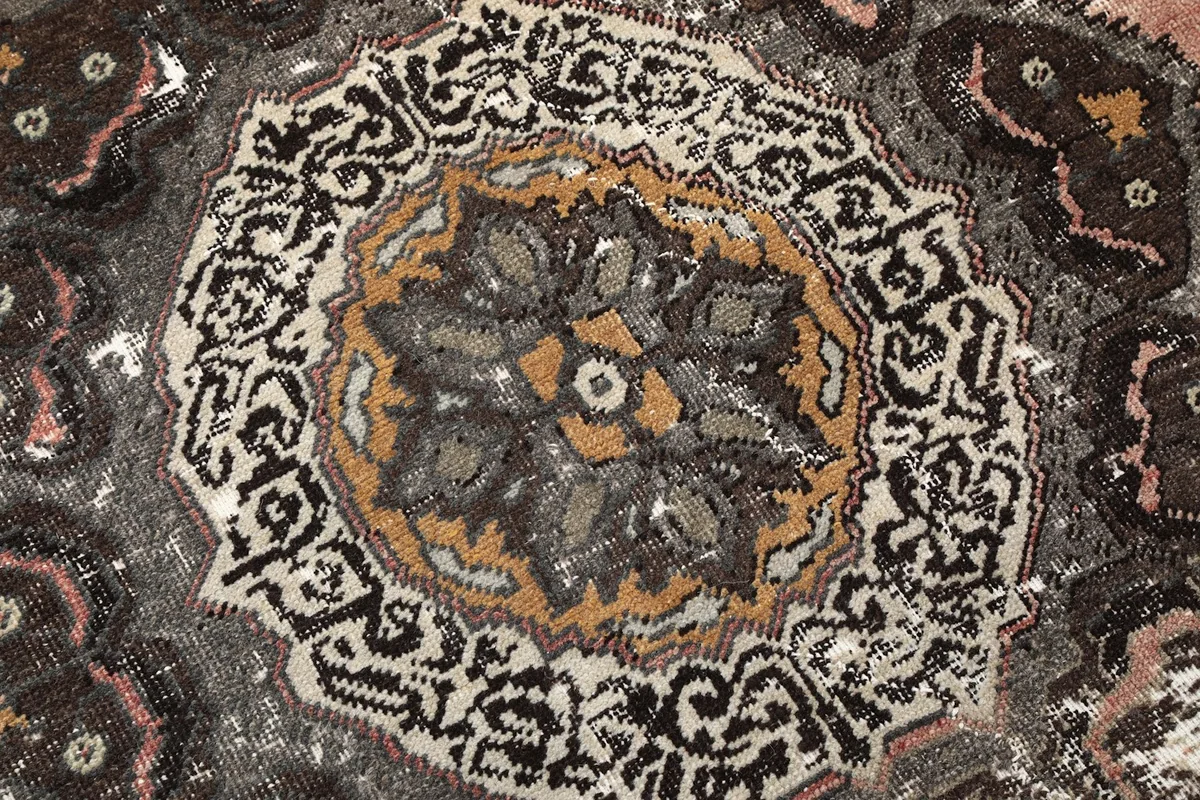 Extreme close-up of the medallion's core, revealing the fine knotting and color blend.