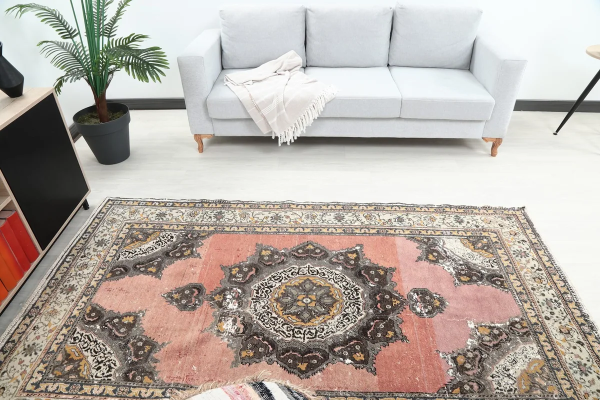 Overhead view of the rug in a room, highlighting the central medallion and border.
