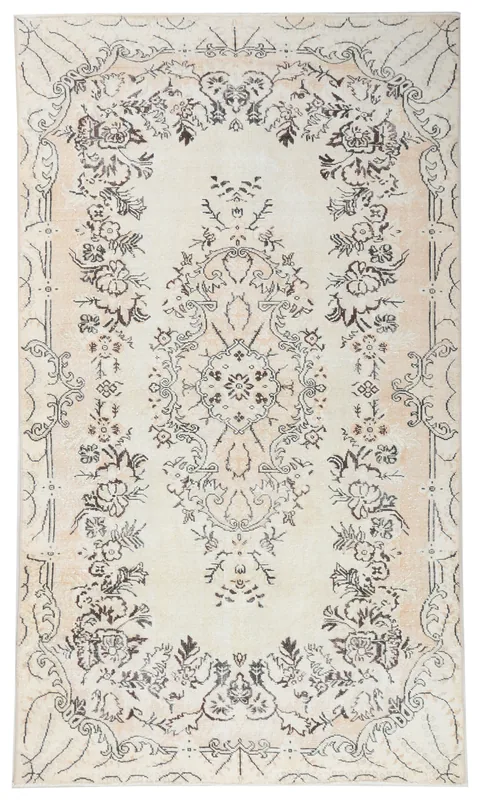 Full overhead view of the 5'6" x 9'6" cream vintage Anatolian rug with botanical medallion on white background