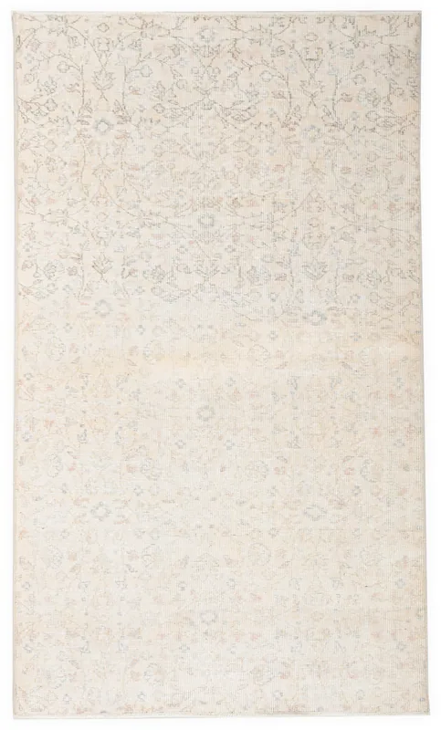 Full top view of the 3'11" x 6'9" ivory vintage Anatolian area rug with subtle floral patterns.