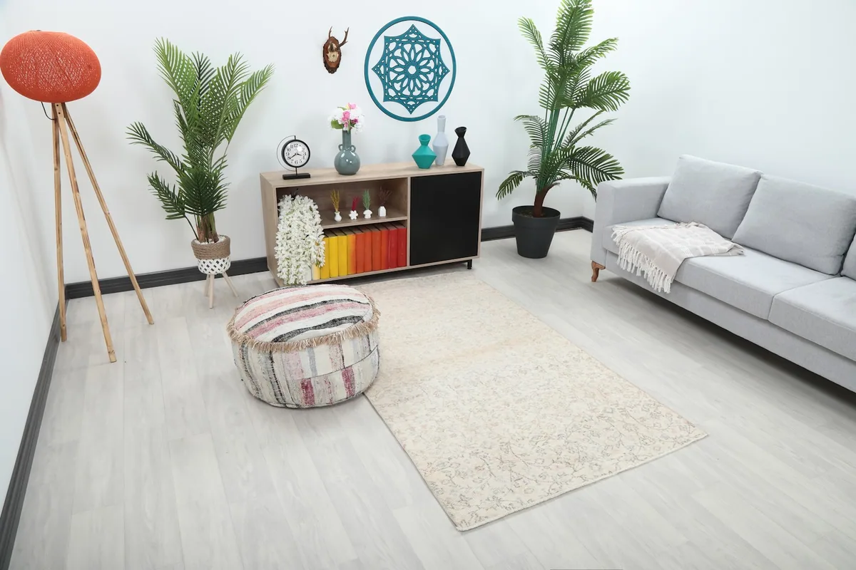 Angle view of the ivory area rug in a room, showing its placement relative to furniture.