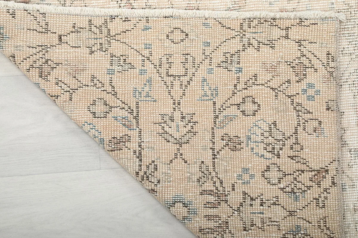Close-up of the rug's back, revealing the detailed knotting and the cotton foundation structure.
