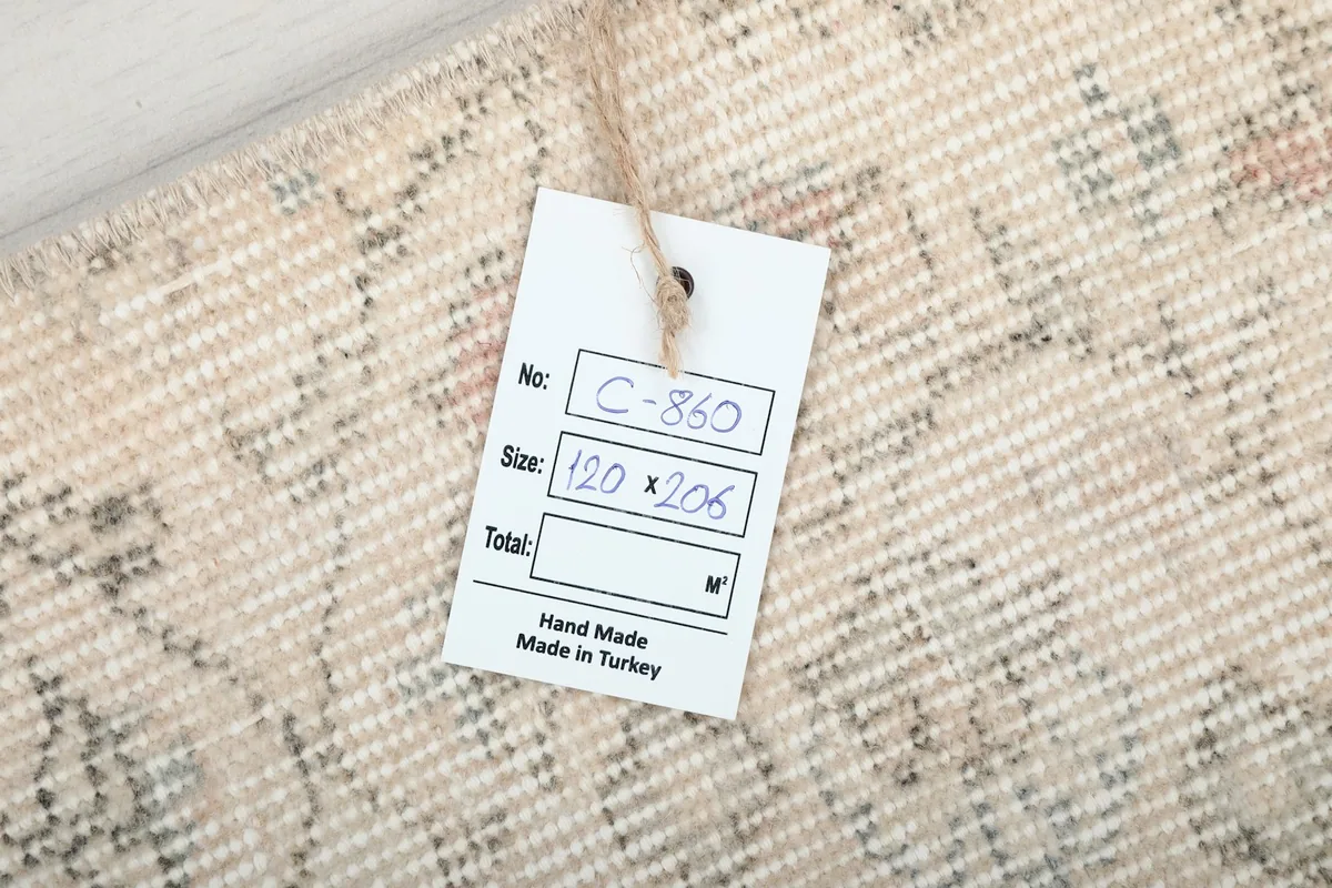 Tag showing the rug's dimensions of 120 x 206 cm and origin as hand-made in Turkey.