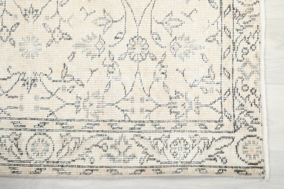 Corner detail of the Faded Ivory Floral Anatolian Rug, highlighting the border design