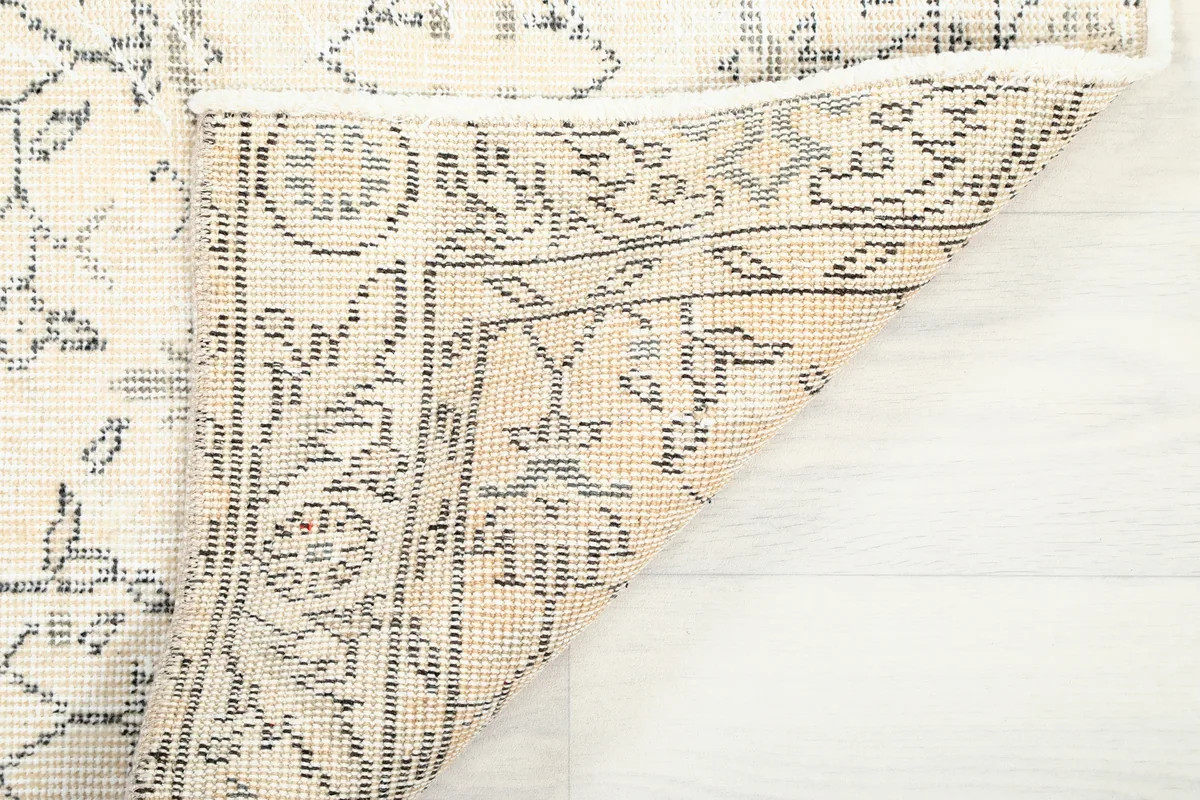 Close-up of the Faded Ivory Floral Anatolian Rug's reverse side, showing the knotting structure