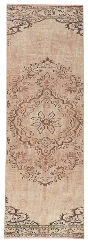 Full overhead view of the beige and brown vintage Anatolian runner rug on a white background.