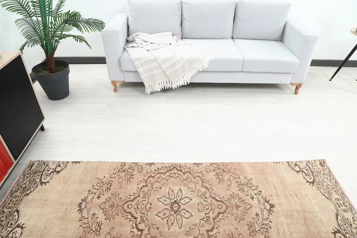 Overhead view of the vintage runner rug in a living room, showing its length and the surrounding decor.