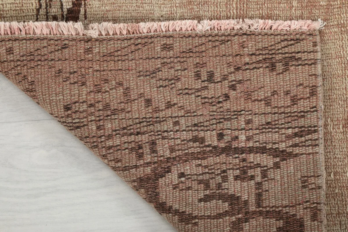 Close-up of the reverse side of the hand-knotted wool runner rug, showcasing the foundation.