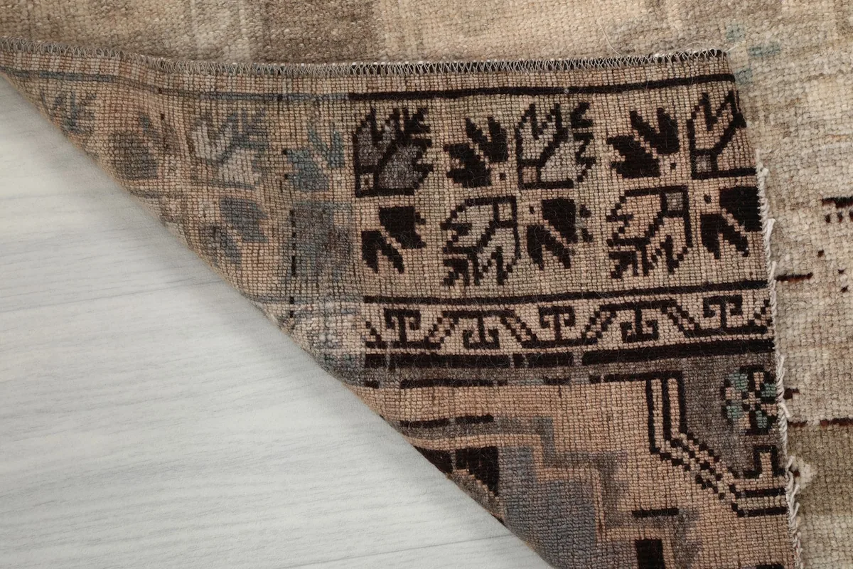 Close-up of the rug's back, showing the tight hand-knotted construction and cotton foundation