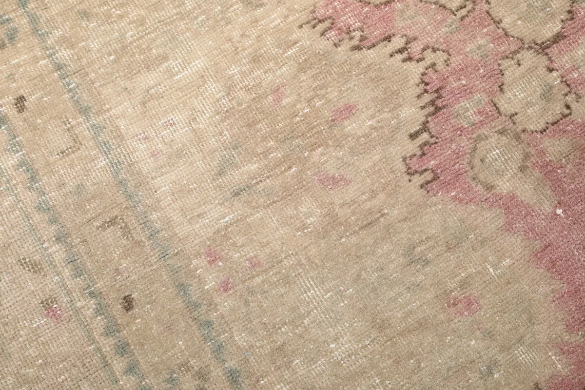 Detailed view of the low wool pile and the subtle color shifts in the vintage rug.