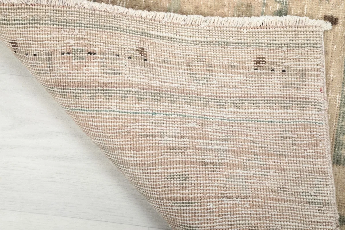 View of the cotton foundation and the back of the hand-knotted wool runner rug.