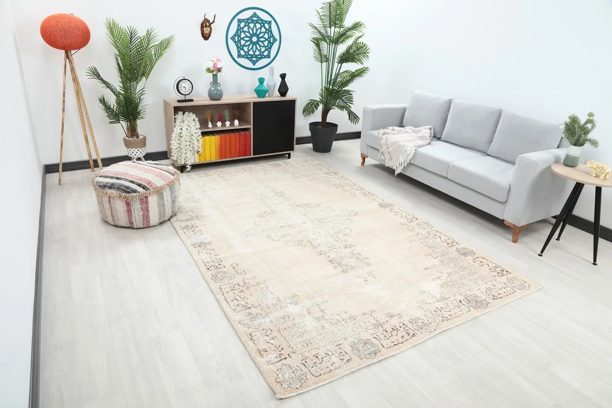 Angle view of the ivory and gray rug in a living room, showing its placement relative to furniture.