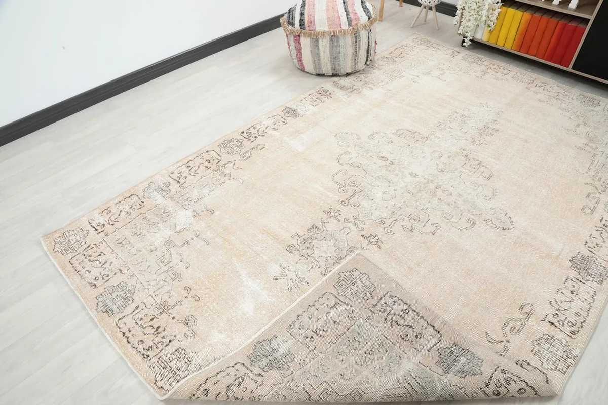 Rug corner folded back to show the cotton foundation and reverse side of the knotting.