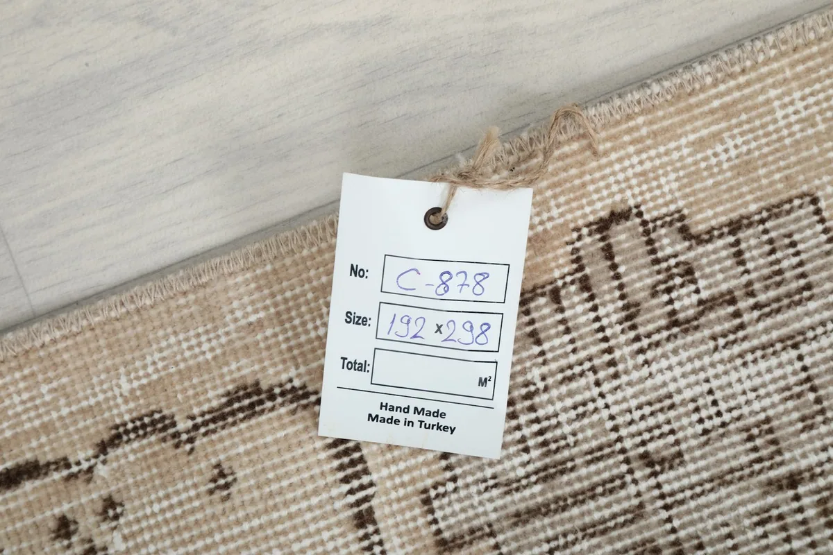 Product tag on the rug showing its dimensions and 'Hand Made in Turkey' label.