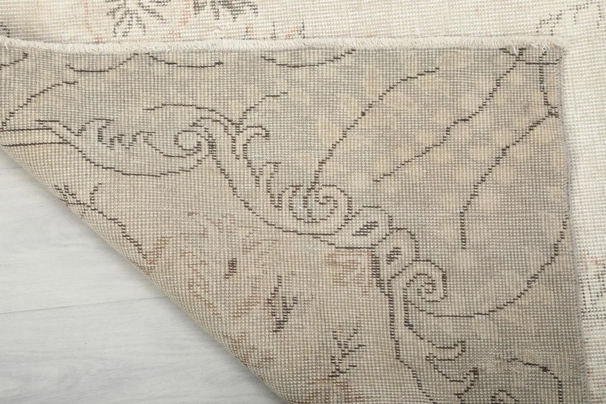 Close-up of the rug's underside, showing the intricate hand-knotted construction and patterns.