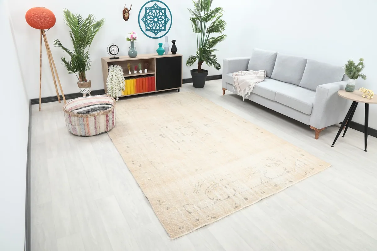 Angle view of the large beige area rug in a light-filled living space