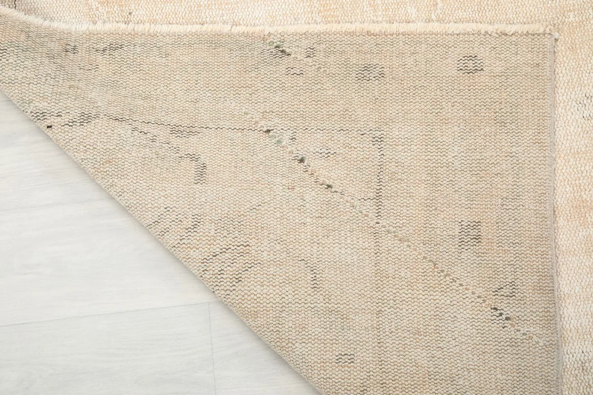 Underside view of the hand-knotted cotton foundation and the reverse of the pattern
