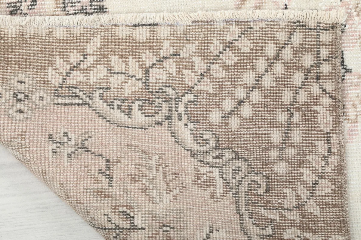 Underside view of the rug, revealing the cotton foundation and hand-knotted construction.