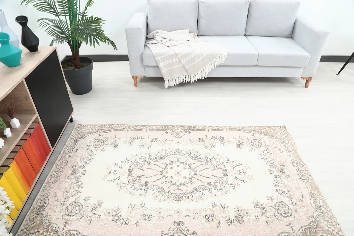 Overhead view showcasing the rug's central medallion and floral patterns in the room setting.