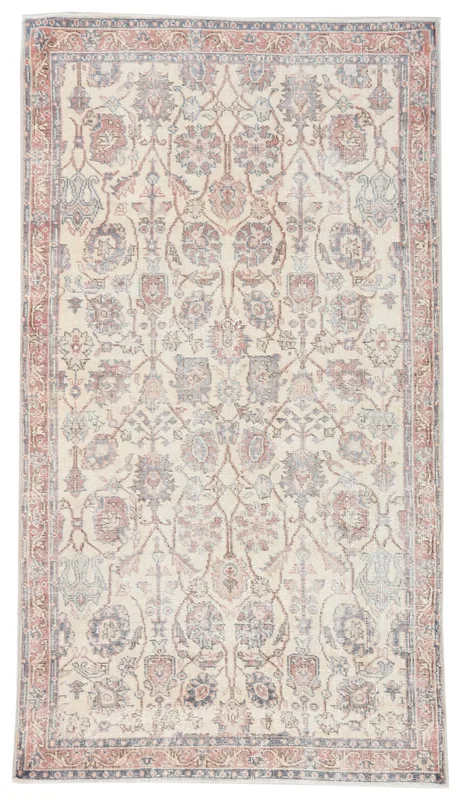 Full top view of the ivory, rose, and blue vintage Anatolian floral rug on a white background