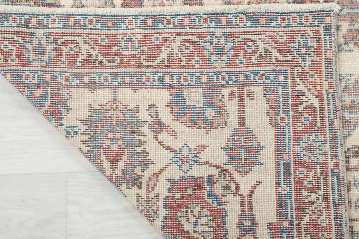 Underside of the rug, showing the dense hand-knotting and cotton foundation