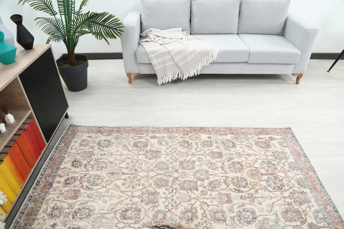 Overhead view focusing on the central floral motifs of the rug within the room setting