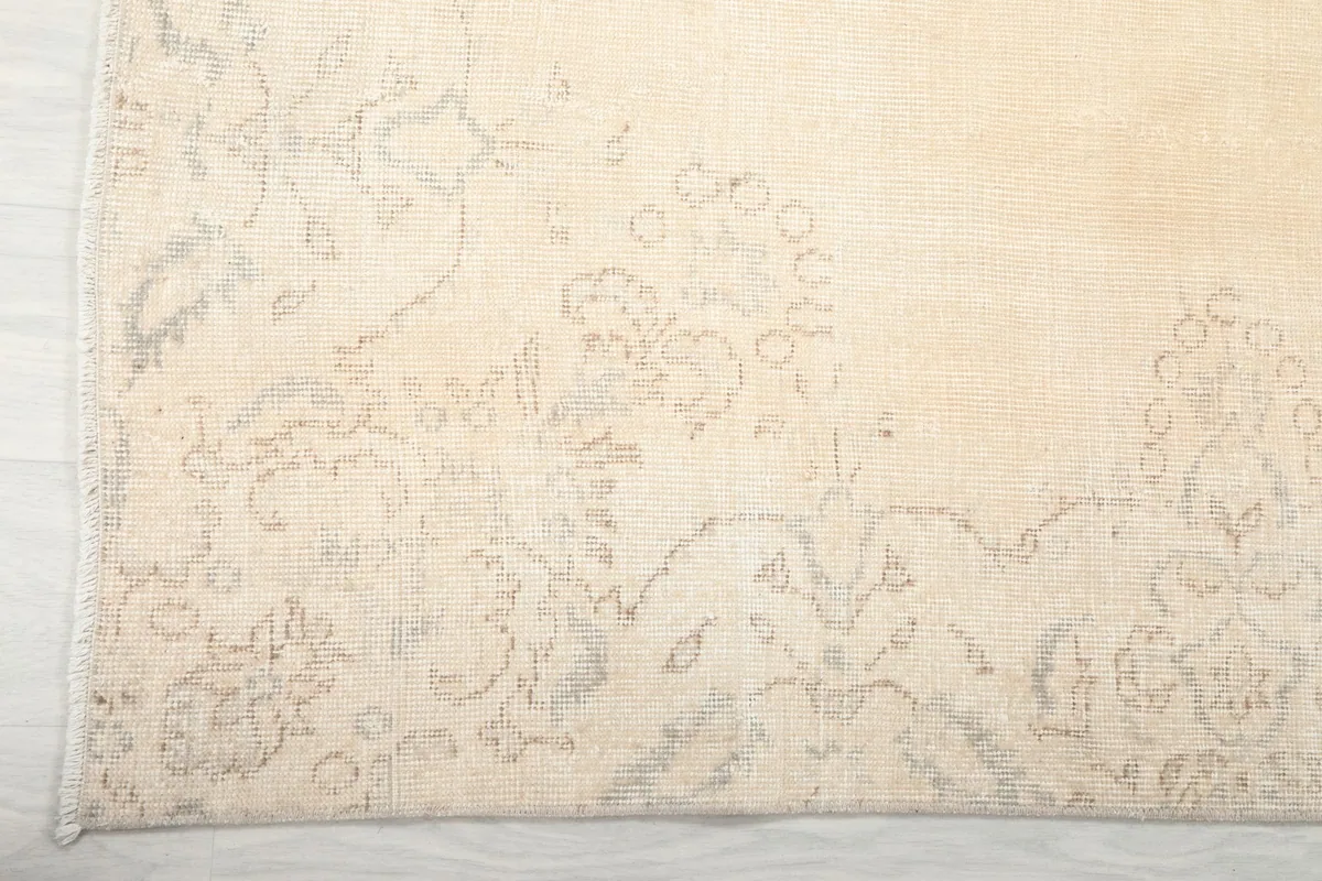 Detail of the border design and corner of the ivory vintage rug