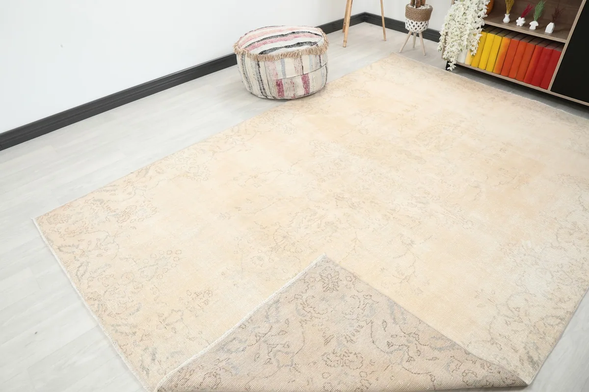 Corner of the rug folded back to show the cotton foundation and reverse side
