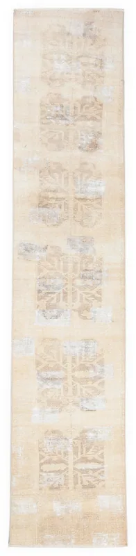 Full overhead view of the beige and tan geometric vintage runner rug on a white background.