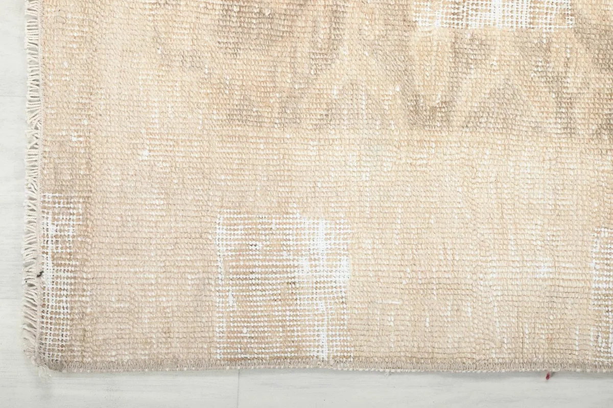Detail of the rug's edge and foundation, highlighting the hand-knotted construction.