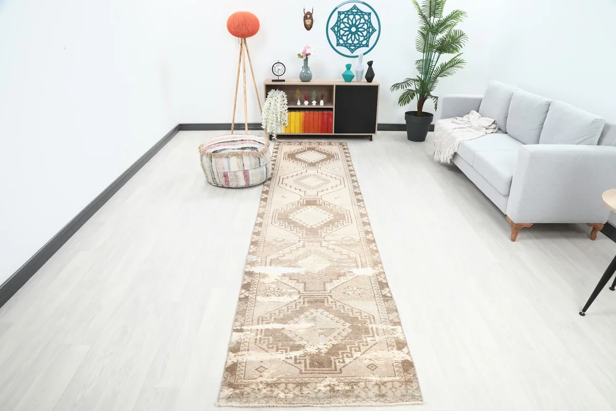 Vintage runner rug laid out in a modern living space, showing its long dimensions and placement