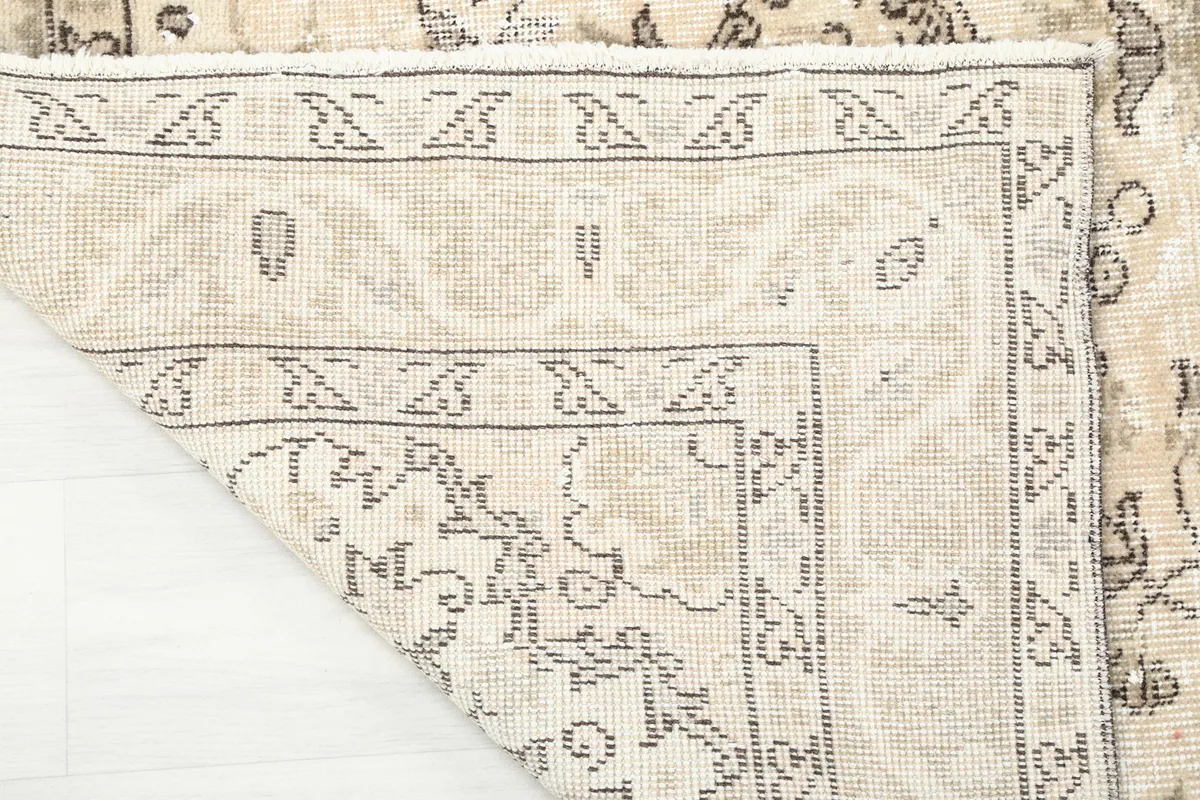 Detail of the rug's cotton foundation and the reverse side of the hand-knotted construction.