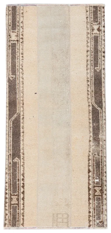 Full top view of the 2'1" x 4'7" vintage Anatolian area rug with beige field and brown geometric borders.