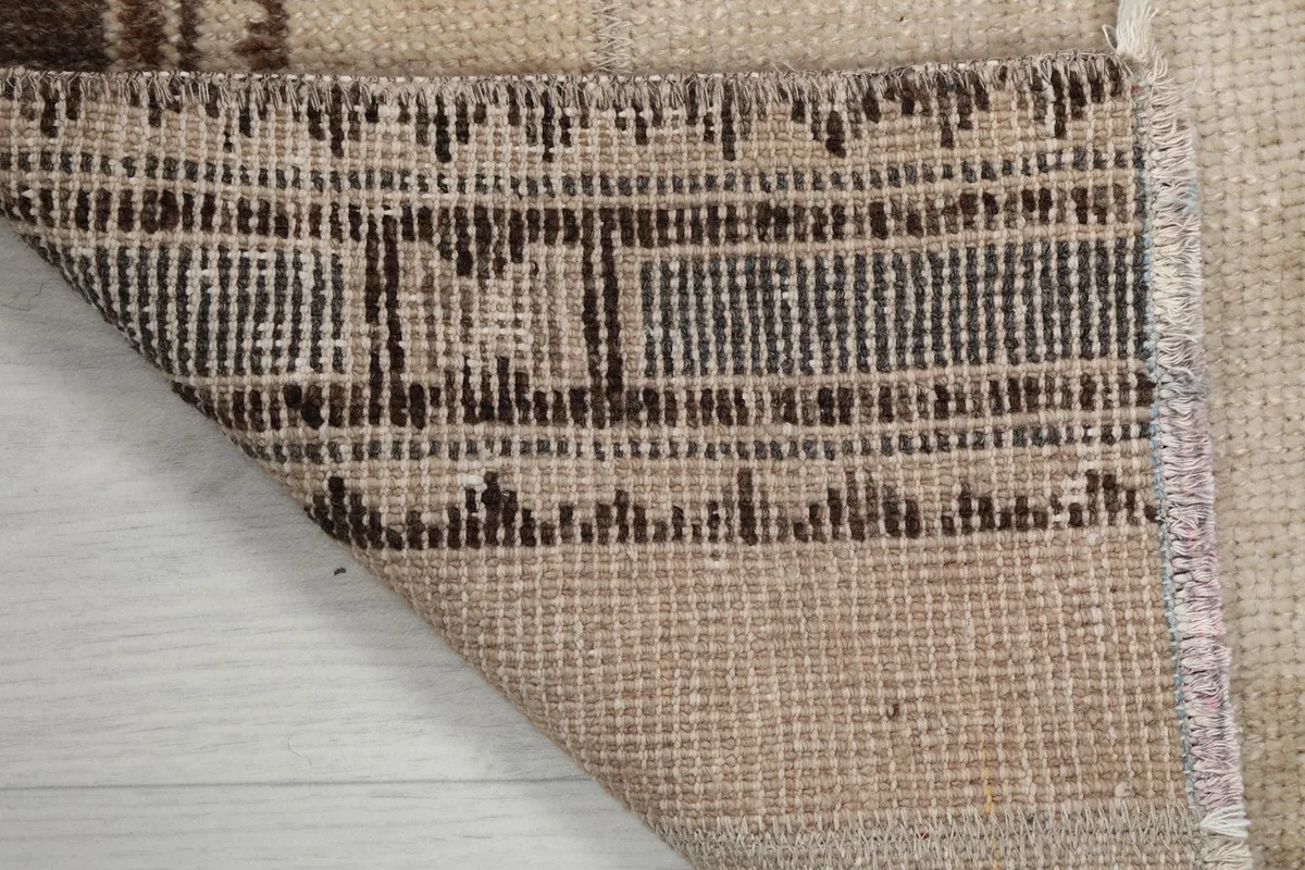 Close-up of the rug's backside, showcasing the tight hand-knotted wool on cotton foundation.