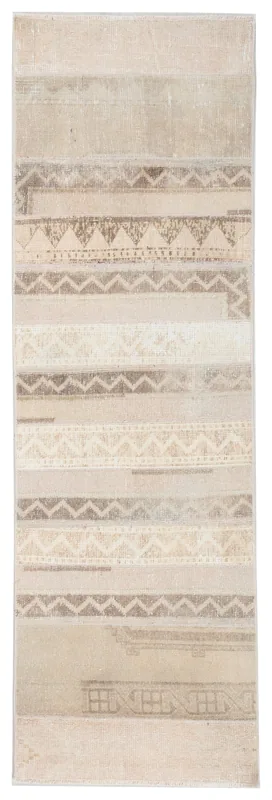 Full top view of the tan and beige geometric vintage Anatolian runner rug on a white background