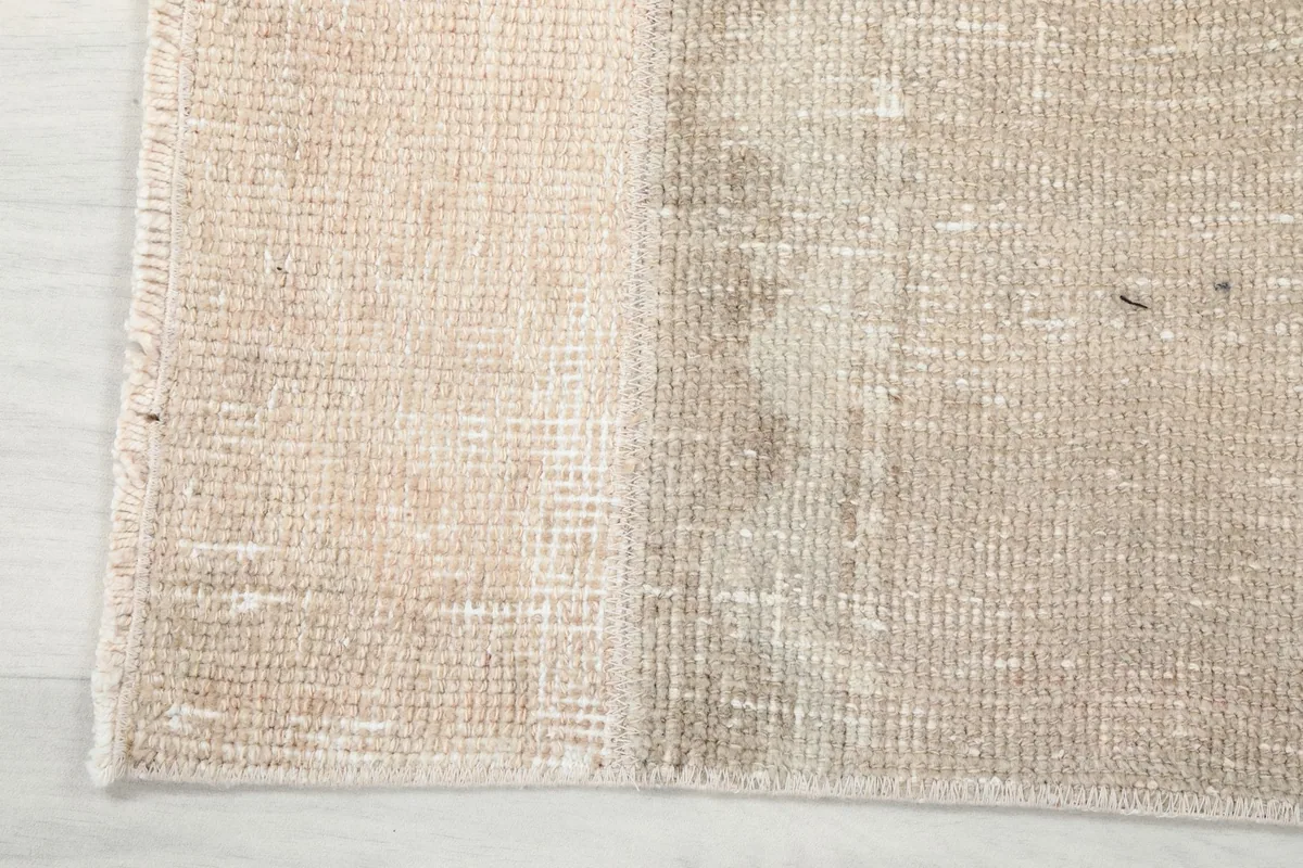 View of the cotton foundation from the back of the vintage hand-knotted runner rug, showing weave