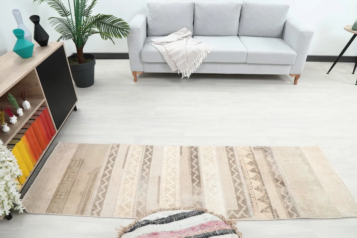 Overhead view of the vintage runner rug in a room, highlighting its full length and banded geometric design