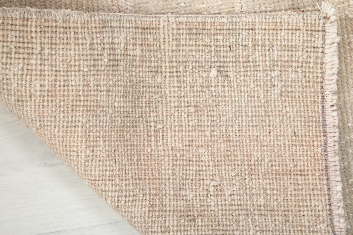 Backside of the Faded Beige Minimalist Anatolian Rug, showcasing the tight hand-knotted cotton foundation.