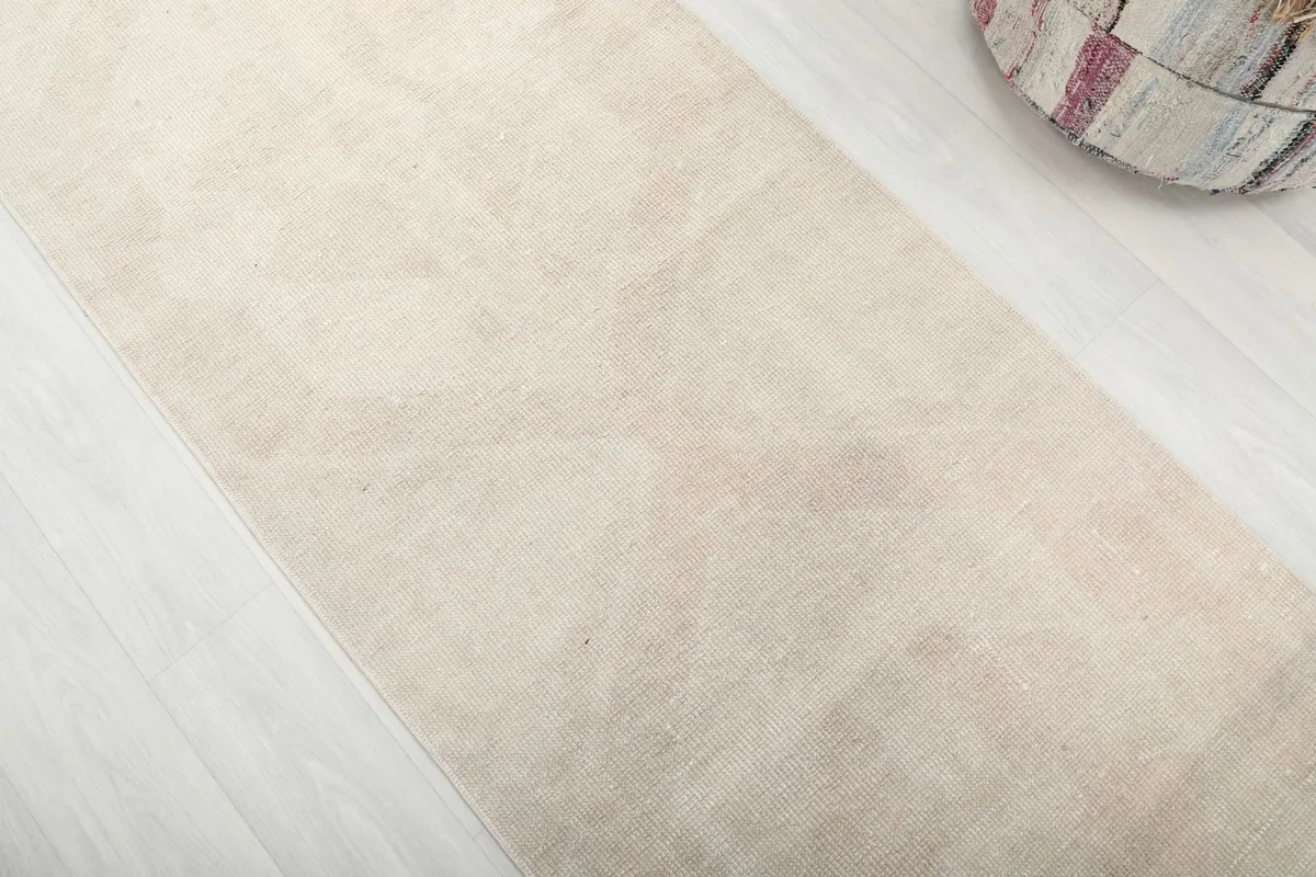 Close-up detail of the rug's faded geometric and medallion patterns and soft texture