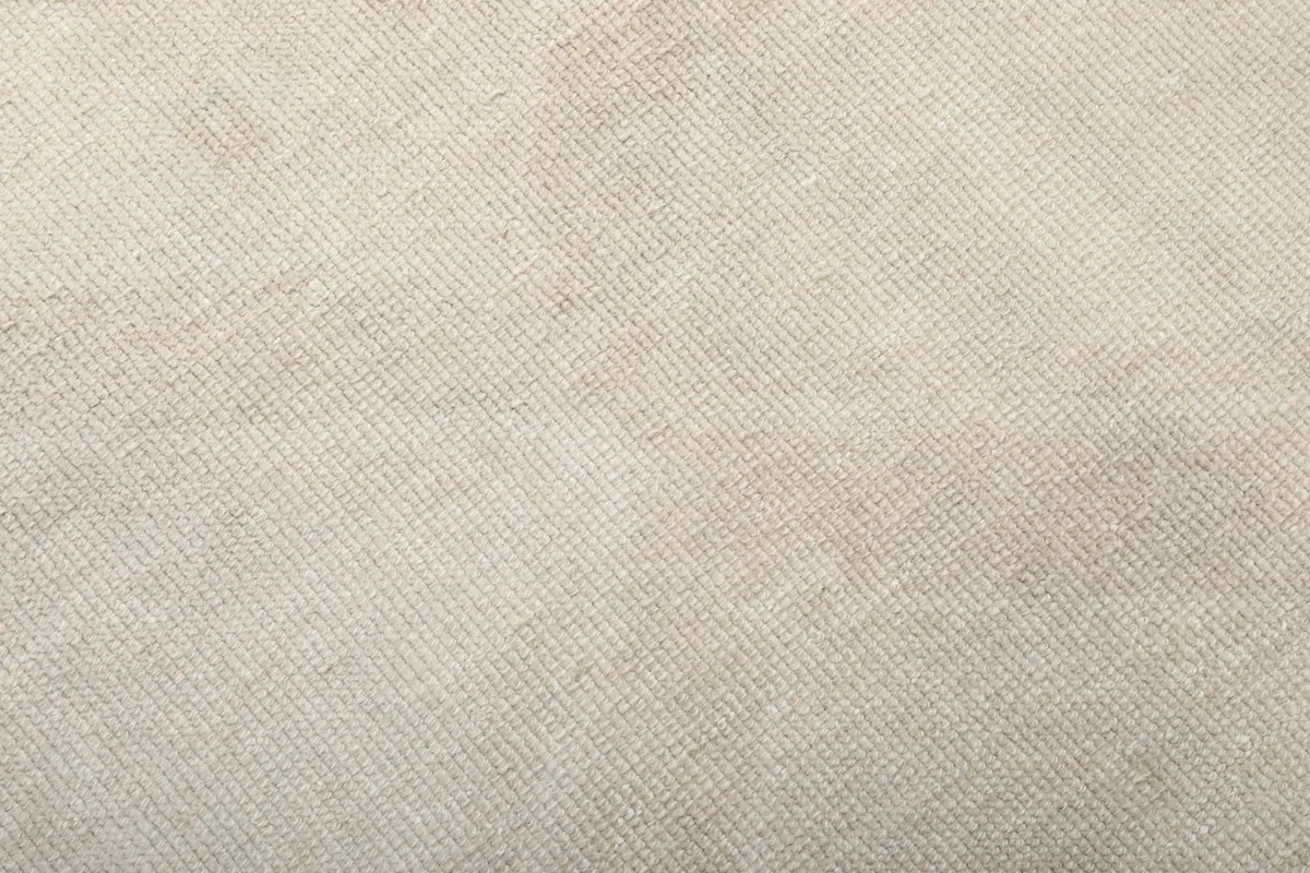 Texture detail of the low wool pile, showing subtle variations in cream and beige