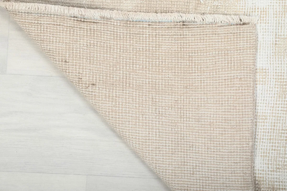 Underside of the rug, showing the tight hand-knotted cotton foundation
