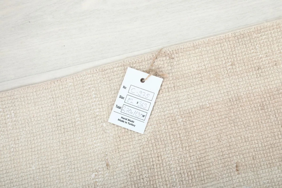 Tag on the back of the rug, indicating hand-knotted origin and material