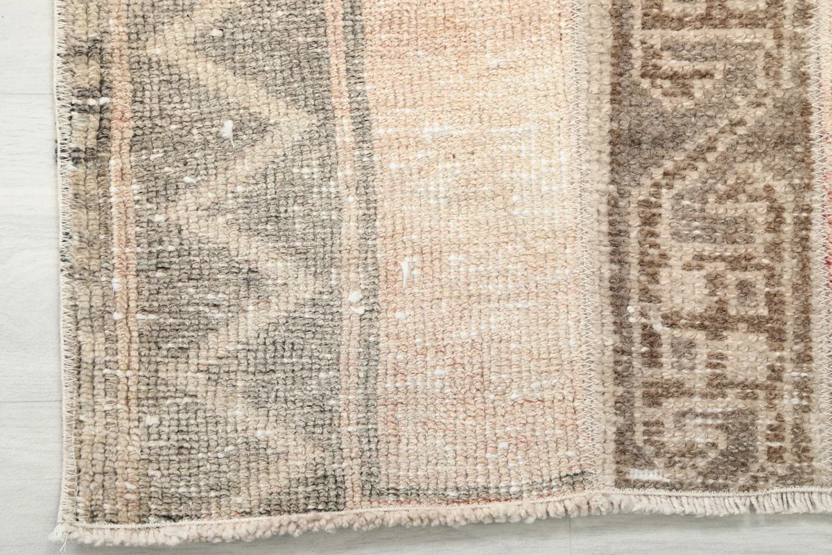 View showing the low pile height and wear on the surface of the wool rug